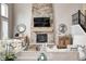 Living room fireplace with stone surround, wooden mantle, and stylish decorative accents at 3387 Keystone Pass, Plainfield, IN 46168
