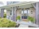 Inviting front porch featuring stylish chairs, a 'hello' doormat, and lush potted ferns at 3387 Keystone Pass, Plainfield, IN 46168