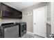 Laundry room featuring modern appliances, upper cabinets and a decorative 'Laundry Co.' sign at 3387 Keystone Pass, Plainfield, IN 46168
