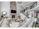 Open living area with soaring ceilings, stone fireplace, and staircase with iron railings at 3387 Keystone Pass, Plainfield, IN 46168