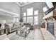 Bright living room with tall windows, coffered ceilings, and a stone fireplace at 3387 Keystone Pass, Plainfield, IN 46168
