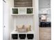 Welcoming mudroom with storage shelves and view into a modern kitchen with stainless steel appliances at 3387 Keystone Pass, Plainfield, IN 46168