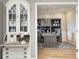 Elegant office space with custom built-ins, patterned wallpaper, and a comfortable workspace at 3387 Keystone Pass, Plainfield, IN 46168