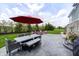 Backyard patio with dining table, shade umbrella, outdoor seating and fire pit at 3387 Keystone Pass, Plainfield, IN 46168