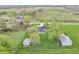 Aerial view of a home, two outbuildings, green lawn, and mature trees at 3710 E 750 S, Lebanon, IN 46052
