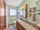 Well-lit bathroom featuring a vanity with a granite countertop and decorative backsplash at 3710 E 750 S, Lebanon, IN 46052