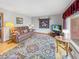 Cozy living room with plush leather seating, hardwood floors, and a bright window view at 3710 E 750 S, Lebanon, IN 46052