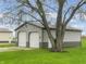 Outbuilding with two garage doors and an entry door with a mature tree in front at 3710 E 750 S, Lebanon, IN 46052