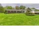 Spacious backyard with lush green lawn and mature trees surrounding the property at 3824 Oakwood Blvd, Anderson, IN 46011