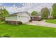 Exterior view showing the home's attached garage and side yard landscaping at 3824 Oakwood Blvd, Anderson, IN 46011