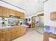 A kitchen with stainless steel refrigerator and wood cabinets with tiled flooring at 3824 Oakwood Blvd, Anderson, IN 46011