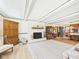 Bright living room featuring a white brick fireplace, wood floors, and ample natural light at 3824 Oakwood Blvd, Anderson, IN 46011