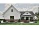 Inviting one-story home featuring white siding, a gray roof, brick foundation, and a cozy front porch at 3932 Besbie Way, Bargersville, IN 46106