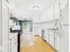 Bright kitchen features white cabinetry, modern appliances, and an adjacent dining area with sliding glass doors at 411 Mccullen St, Chesterfield, IN 46017