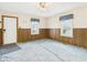 Spacious living room with wood paneling, carpet, and natural light from the windows with decorative valances at 411 Mccullen St, Chesterfield, IN 46017