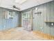 View of the living room with wood paneling and sliding doors leading to deck at 411 Mccullen St, Chesterfield, IN 46017