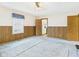 Spacious living room with wood paneling, carpet, and natural light from the windows with decorative valances at 411 Mccullen St, Chesterfield, IN 46017