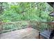 A wood back deck provides a private outdoor space surrounded by lush greenery at 4212 Foxglove Trce, Indianapolis, IN 46237
