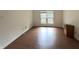 Cozy bedroom featuring vinyl floors, white walls, and a window with tree views at 4212 Foxglove Trce, Indianapolis, IN 46237