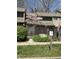 Charming townhome featuring flowering trees and a well-maintained wooden fence for added privacy at 4212 Foxglove Trce, Indianapolis, IN 46237