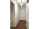 Bright hallway with white walls, wood-look floors, and a front door with decorative glass pane at 4212 Foxglove Trce, Indianapolis, IN 46237