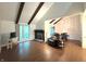 Spacious living room with vaulted ceiling, wood beams, fireplace, and ample natural light at 4212 Foxglove Trce, Indianapolis, IN 46237