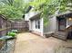 Charming side exterior featuring a private patio area, decorative accents, and a serene, garden-like atmosphere at 4212 Foxglove Trce, Indianapolis, IN 46237