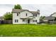 Lush green backyard featuring a well-maintained lawn, the home's exterior and an outdoor patio set at 4227 Short Ter, Carmel, IN 46033