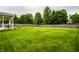 Large, green backyard enclosed by a wooden fence, offering ample space and privacy at 4227 Short Ter, Carmel, IN 46033