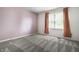 Comfortable bedroom with light pink walls, plush carpet, and window with privacy blinds at 4227 Short Ter, Carmel, IN 46033
