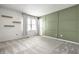 Cozy bedroom with decorative green accent wall, soft carpet, and bright natural light at 4227 Short Ter, Carmel, IN 46033