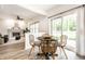 Bright dining area features a round table and wicker chairs, with natural light pouring through sliding glass doors at 4227 Short Ter, Carmel, IN 46033
