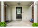 Close-up of the front porch featuring a decorative front door with sidelights and a security system at 4227 Short Ter, Carmel, IN 46033