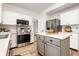 Clean kitchen with white cabinets, stainless steel appliances, and gray island with butcher block countertop at 4227 Short Ter, Carmel, IN 46033