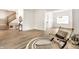 Spacious living area with stairs in view featuring modern flooring and neutral decor for an airy, welcoming space at 4227 Short Ter, Carmel, IN 46033