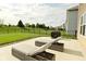 Spacious backyard featuring a concrete patio with chaise lounges and lush green grass at 4396 Nigella Dr, Plainfield, IN 46168