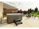 Relaxing backyard patio with hot tub, fire pit, and plenty of seating at 4396 Nigella Dr, Plainfield, IN 46168