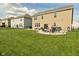 Large backyard featuring a patio with seating, hot tub, and well-maintained lawn at 4396 Nigella Dr, Plainfield, IN 46168