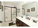 Bathroom features a double sink vanity, sleek tile floors, and a glass-enclosed walk-in shower at 4396 Nigella Dr, Plainfield, IN 46168