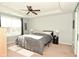 This bedroom features natural light from a large window and a ceiling fan at 4396 Nigella Dr, Plainfield, IN 46168