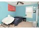 Bright bedroom features blue walls, fan, modern chair, and plenty of natural light from the large window at 4396 Nigella Dr, Plainfield, IN 46168