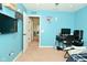 Bright bedroom features blue walls, a gaming desk and computer, with easy access to the hall at 4396 Nigella Dr, Plainfield, IN 46168