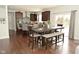 Dining area adjacent to the kitchen, featuring hardwood floors and a modern dining set at 4396 Nigella Dr, Plainfield, IN 46168