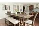 Dining area with hardwood floors and view to living and kitchen spaces, offering great flow and natural light at 4396 Nigella Dr, Plainfield, IN 46168
