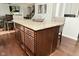 Kitchen island featuring granite countertop, cabinet storage, and bar stool seating facing the dining and living areas at 4396 Nigella Dr, Plainfield, IN 46168
