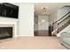 View of a living room with a fireplace, staircase, and entrance at 4396 Nigella Dr, Plainfield, IN 46168