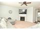 Inviting living room featuring a cozy fireplace, ceiling fan, and comfortable sectional sofa at 4396 Nigella Dr, Plainfield, IN 46168