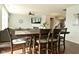 Open concept living room with hardwood floors, modern ceiling fan, and view of staircase and dining area at 4396 Nigella Dr, Plainfield, IN 46168