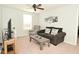 Cozy living room with neutral walls, ceiling fan, natural light, plush sofa, and comfortable recliner at 4396 Nigella Dr, Plainfield, IN 46168