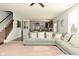 Bright living room with a plush sectional sofa, a staircase, and an open view to the kitchen at 4396 Nigella Dr, Plainfield, IN 46168